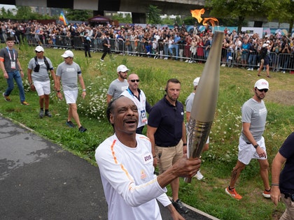 Snoop Dogg Carrying The Olympic Torch In Paris